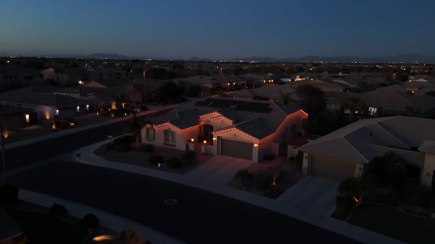 Red roofline lighting at dusk